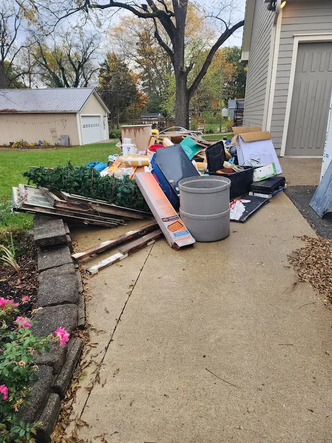 Dumpster being loaded with debris for Commercial Dumpster Rental in Camden
